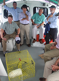 House delegates and officials from VIMS and VMRC listen to a discussion on the use of biodegradable panels to reduce by-catch in abandoned crab pots.