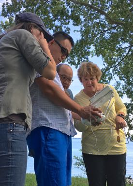 From L: VIMS Ph.D. student Lydia Bienlien works with professors Donglai Gong, BK Song, and Kim Reece to control the drone in flight. ©D. Malmquist/VIMS.