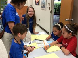 A team of young reporters--the AHG Narwhals--file their stories after returning to the newsroom. ©VIMS.