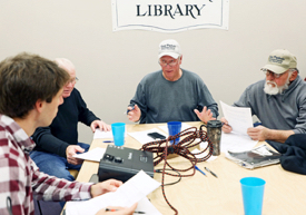 Local waterman J.C. Hudgins (C) talks with VIMS graduate student Jim DelBene (L) during a focus group to develop his survey. © A. Devlin/VASG.