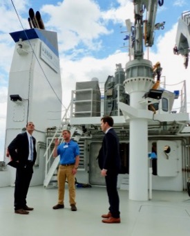 Taylor Moore (C), mate aboard the RV {em}Virginia{/em}, describes the vessel's capabilities to Virginia Secretary of Natural Resources Matt Strickler (L) and W&M Board of Visitors member Will Payne (R) during a pre-christening tour. © D. Malmquist/VIMS.