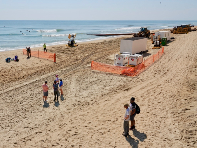 The researchers chose the largely undisturbed Virginia Barrier Islands for their study to avoid complications introduced by beach nourishment, such as that underway here on the Outer Banks of North Carolina. In the foreground is study co-author Dr. Chris Hein, along with W&M undergraduate Ethan Stewart. © D.Malmquist/VIMS.