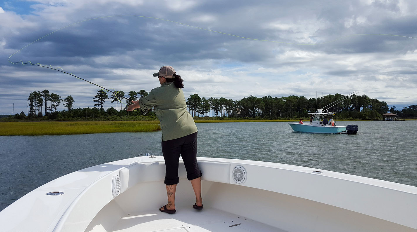 An angler casts her fly line near a marsh in Virginia’s Middle Peninsula.