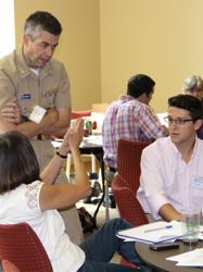 Ike Irby (R) discusses flooding issues with fellow attendees at a meeting of the Virginia Coastal Policy Clinic.