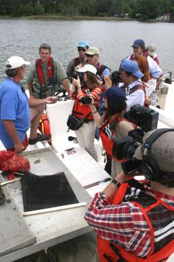 Mr. Tommy Leggett of Chessie Seafood and Aquafarms talks with the foreign reporters during their visit to VIMS. 